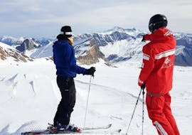 A skier is contemplating the ski area where their Private Ski Lessons for Adults of All Levels is going to take place with the ski school ESS Château d'Oex.