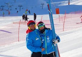 Two ski instructors of the Escola Vall De Boí having fun together while getting ready for the Adult Ski Lessons for All Levels.