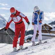 A women has fun during her private ski lesson for adults of all levels with her ski instructor of Privatskischule Kleinwalsertal.