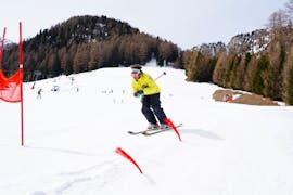 A ski instructor of Maestri di sci Moena ski school going down the beautiful Alpe di Lusia slopes during the Adult Ski Lessons for All Levels.
