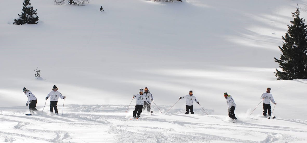 Ski instructors training in fresh snow in Moena before one of the Moena - Adult Ski Lessons for All Levels.
