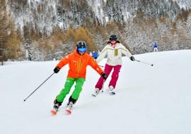 A skier is following her ski instructor from the ski school Evolution 2 La Plagne Montchavin - Les Coches on the slope during her Private Ski Lessons for Adults of All Levels.