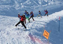 Kids Ski Lessons (3-16 y.) for Skiers with Experience from Swiss Ski School Zweisimmen A group of children is following their ski instructor from Schweizer Skischule Zweisimmen down the slope during their Kids Ski Lessons (3-16 y.) for Kids with Experience.