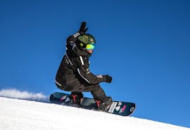 A snowboard instructor of the ski school Giorgio Rocca Ski Academy St.Moritz is going confidently down the beautiful St.Moritz slopes, teaching his students how to improve their skills during the Private Snowboarding Lessons for Kids&Adults of All Levels.