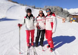 Three ski intructors of Hansis Skischule Steinach am Brenner are posing for a picture on the slopes of Bergeralm where they offer Private Ski Lessons for Adults of All Levels.