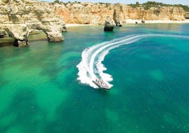 A boat is cruising along the coastline during a Boat Trip to the Cave of Benagil from Portimao with Seadventure Boat Trips Algarve. 