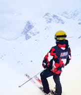 A skier looking down the slope at her Private Ski Lessons for Adults of All Levels from Skischule Olympic Hugo Nindl Axamer Lizum.
