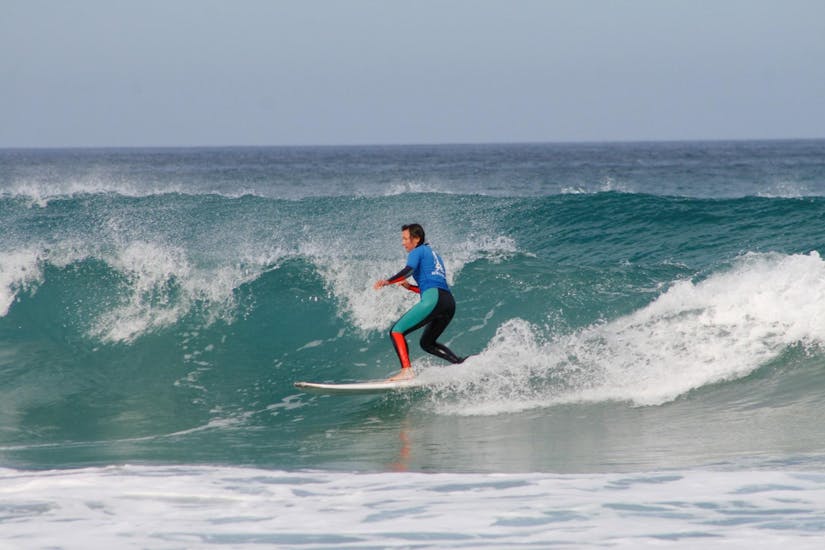 A person riding a wave during Private Surfing Lessons on Famara Beach with Surf & SUP School3S Lanzarote.
