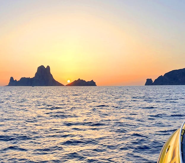 A woman admiring the sunset during a Private Sunset Boat Trip along the Ibiza Coast with Take Off Ibiza.