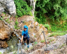 Woman smiling at the camera while on the Via Ferrata Cascata with SKYclimber Tremosine