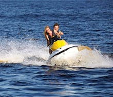 A couple is having fun while exploring the surroundings of Malta during a Jet Ski Safari to Comino & Blue Lagoon with Oh Yeah Malta.