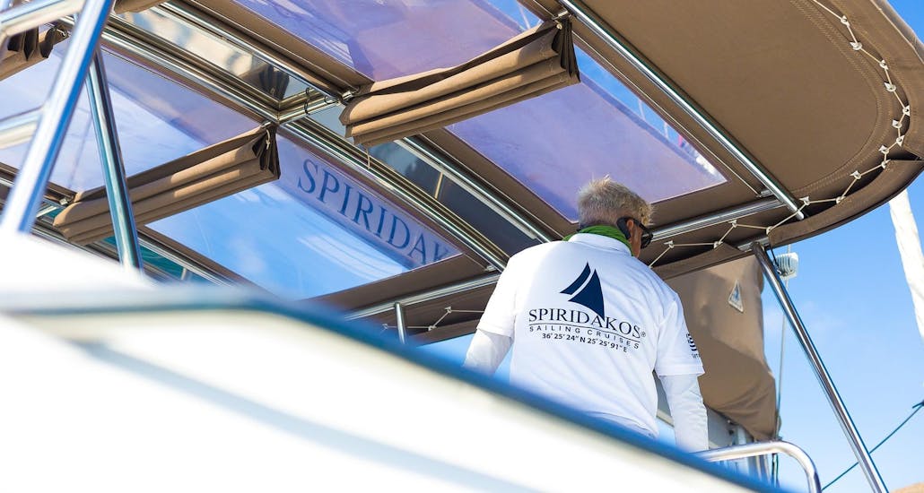 The captain of Spiridakos Sailing Cruises takes care of their customers during the private sunset cruise around the hotspots of Santorini.
