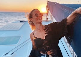 A woman enjoys the Private Sunset Boat Trip with Volcano Hike with Spiridakos Sailing Cruises Santorini.
