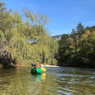 An old man is enjoying the Classic tour of 12km during the Canoe Rental on the Tarn with Canoe La Cazelle Gorges du Tarn.