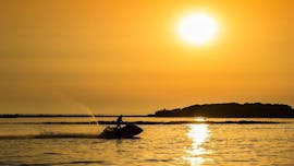 The silhouette of a jet ski from Jet Ski Rent Dubrovnik and its driver, driving into the sunset 