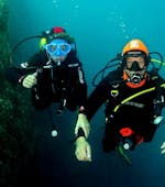 An instructor is accompanying a tourist for his Trial Dive at Le Lion de Mer with Aventure Sous-marine Saint-Raphaël.