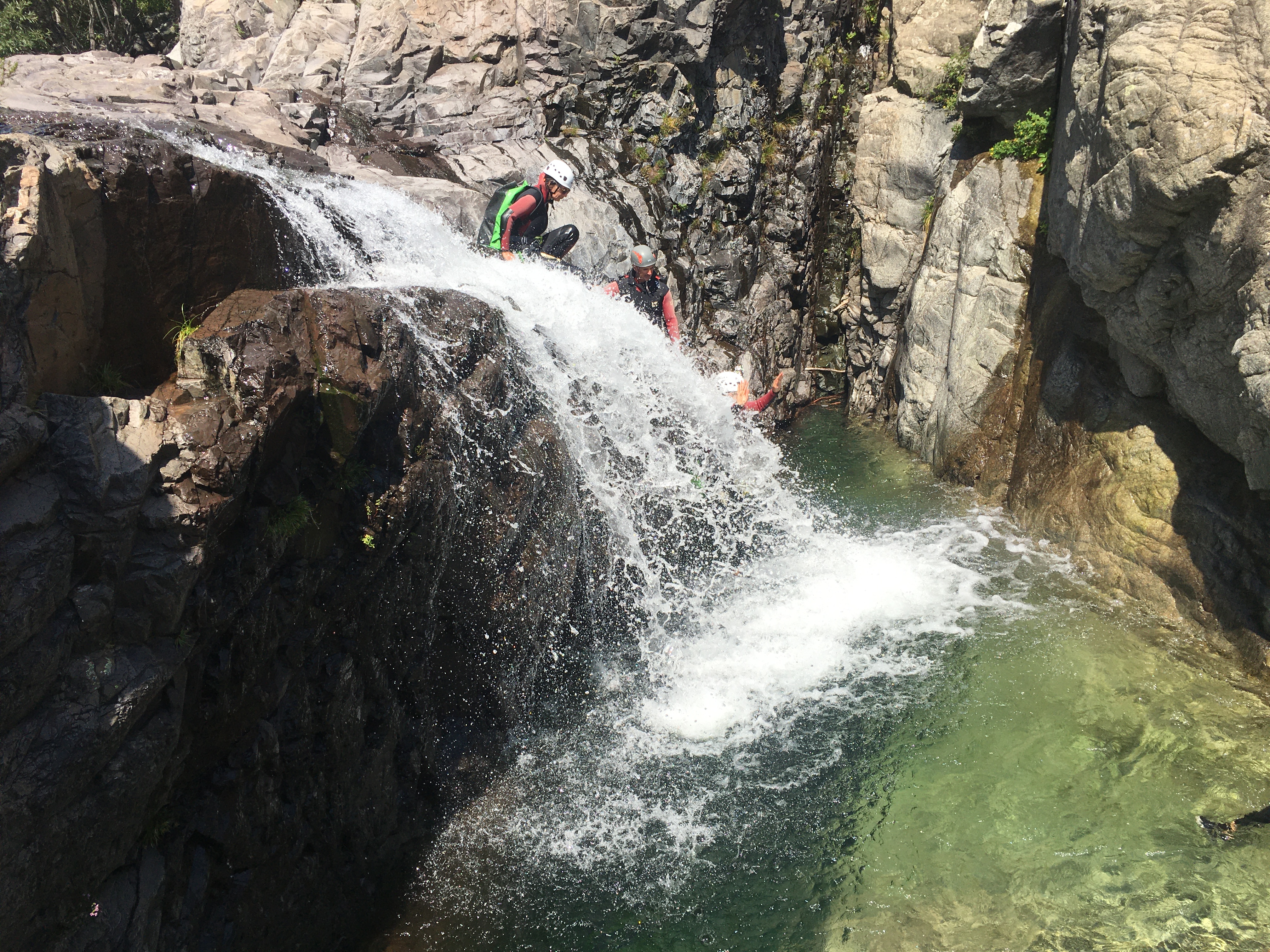Jumping from a waterfall during the full day canyoning in Dardu Canyon hosted by Canyon Corse.