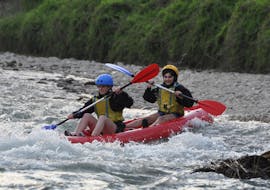 Two friends are having a lot of fun during the Kayak on the Adige River in the Terra dei Forti with Pescantina Rafting Bussolengo.