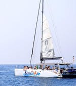 The catamaran from Catamaran Sensations is sailing across the blue waters of the Costa Brava during the Catamaran Trip along Costa Brava with Swimming & Snorkeling.