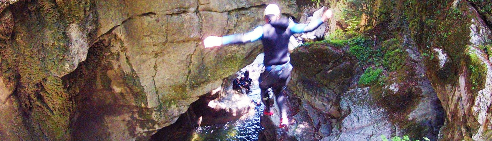 Ein Teilnehmer springt in ein natürliches Becken im Canyon du Pont-du-diable während einer abenteuerlichen Canyoningtour mit Takamaka Aix-les-Bains