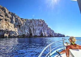 A woman enjoys the sun on Board during the boat trip to Kornati Telascica National Park with Zadar Day Trips from Zadar.
