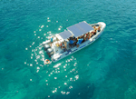 Eines der Boote von Vie del Mediterraneo bahnt sich seinen Weg über das blaue Wasser während der Bootstour von Porto Cesareo nach Punta Prosciutto.