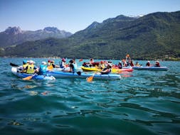 Group of people having fun kayaking during their Kayak Rental on Annecy Lake with Wake & Ski 74.
