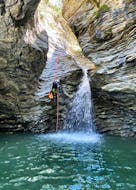 A brave participant is roping down the canyon during the canyoning starting from Taormina with Sicilia Adventure.