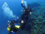 Un élève et son moniteur communiquent sous l'eau pendant le Cours de plongée Niveau 1 FFESSM pour Débutants avec European Diving School Hyères.