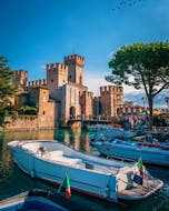 The motorboats of Sirmione Boats stopped at the port in front of the Castle waiting for the arrival of customers before a Boat Trip along the Sirmione peninsula.