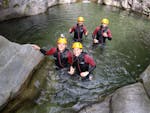 A family having fun while Canyoning in the Corippo Canyon with Ticino Adventures.
