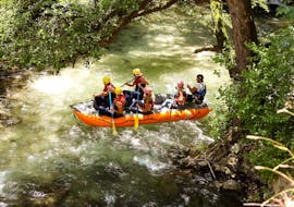 A family paddles aboard a raft enjoying the unspoiled Valnerina nature during a rafting tour on the Corno river - long route with Rafting Umbria. 