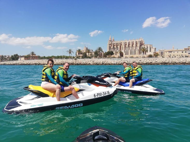 A group goes on a jet ski safari to the cathedral of palma with Mallorca on jetski.