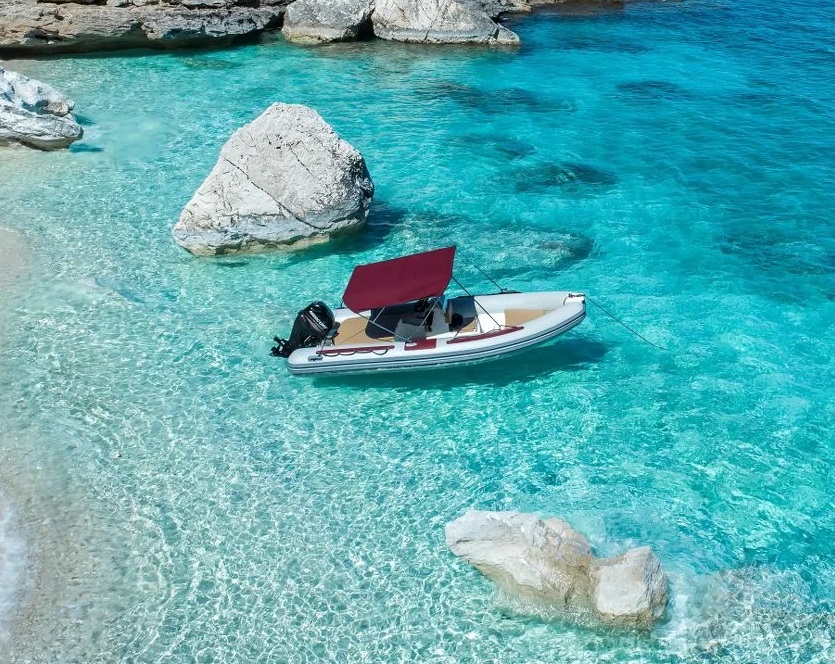 A RIB boat is mooring in the crystal clear water off the coast of the Gulf Of Orosei during the RIB Boat Rental in Cala Gonone (up to 6 people).