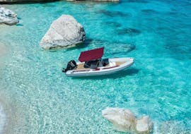 A RIB boat is mooring in the crystal clear water off the coast of the Gulf Of Orosei during the RIB Boat Rental in Cala Gonone (up to 6 people).
