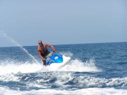 A man rides a jetski in St George's Bay from Sun & Fun Watersports Malta.