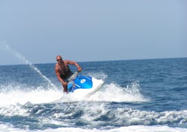 A man rides a jetski in St George's Bay from Sun & Fun Watersports Malta.