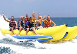 A group of young people enjoy a banana boat ride in St George's Bay with Sun & Fun Watersports.