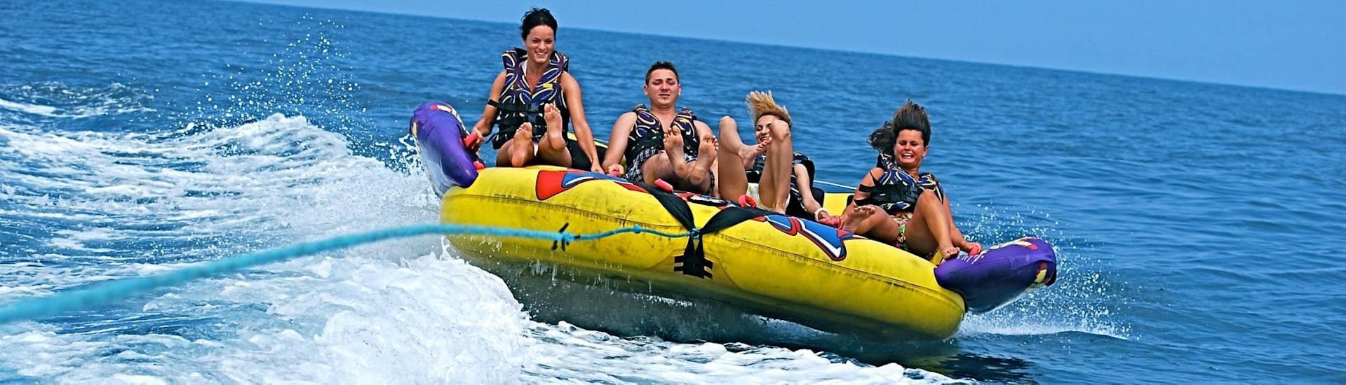 A group of friends rides the crazy sofa in St George's Bay with Sun & Fun Watersports.