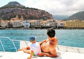 During a Private Boat Trip in Cefalù with Sightseeing with Sea Land Tours Cefalù a little boy and his dad look at the view. 