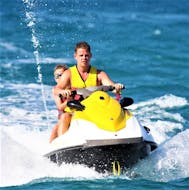 Two people enjoy a jet ski ride at Ammourada Beach with H2O Water Sports Heraklion. 
