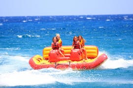 A family goes on an inflatable ride at Ammourada Beach with H2O Water Sports Heraklion. 