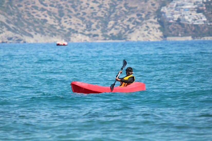 Man enjoying himself during his Sea Canoe Hire at Ammoudara Beach from H2O Water Sports Heraklion.