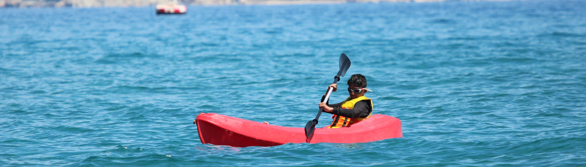 Man enjoying himself during his Sea Canoe Hire at Ammoudara Beach from H2O Water Sports Heraklion.