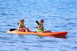 Two girls go on a sea canoe in Ammoudara Bay with H2O Water Sports Heraklion.