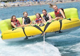 People on a Towed Buoy at Faliraki Beach  with Sotos Watersports. 