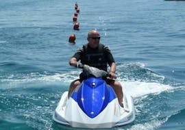A man is riding a jet ski on Stafilia Beach with Sabina's Watersport Rhodes.