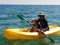 A woman is taking advantage of the sea kayak hire on Stafilia Beach by Sabina's Watersport Rhodes to paddle along the coastline of Lardos in Rhodes.