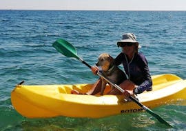 A woman is taking advantage of the sea kayak hire on Stafilia Beach by Sabina's Watersport Rhodes to paddle along the coastline of Lardos in Rhodes.