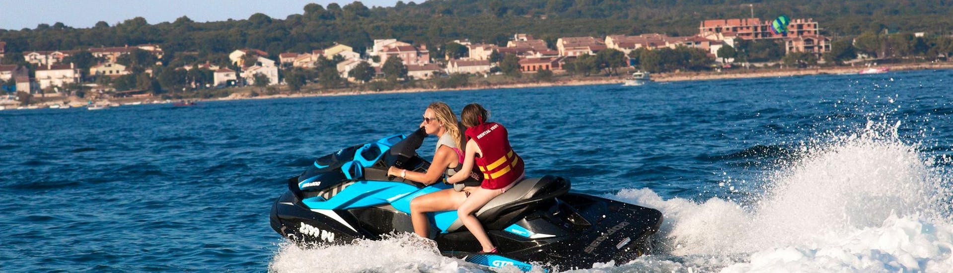 Two people doing Jet Ski at Cape Kamenjak with Premantura Watersports. 
